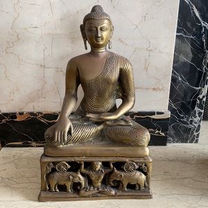 Dramatic and detailed bronze-colored/metal Buddha.